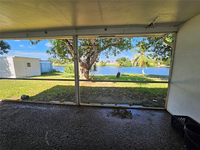 unfurnished sunroom featuring a water view