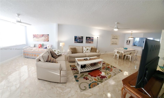 living room featuring a textured ceiling and ceiling fan