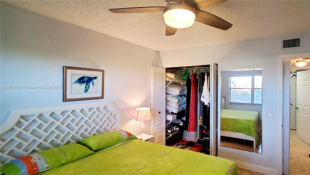 bedroom with ceiling fan and a closet