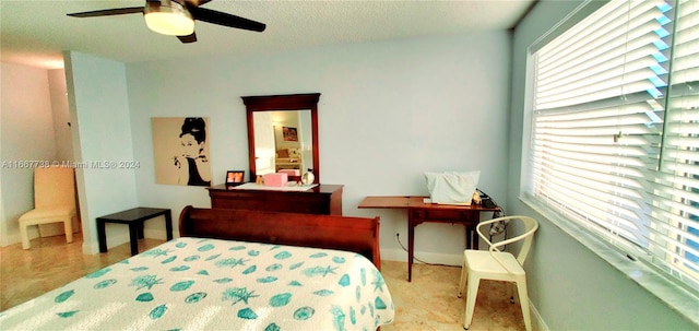 carpeted bedroom featuring ceiling fan and a textured ceiling