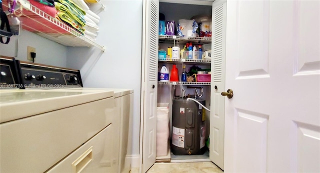 washroom with washer and clothes dryer and water heater