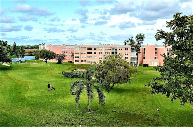 view of home's community featuring a water view and a yard