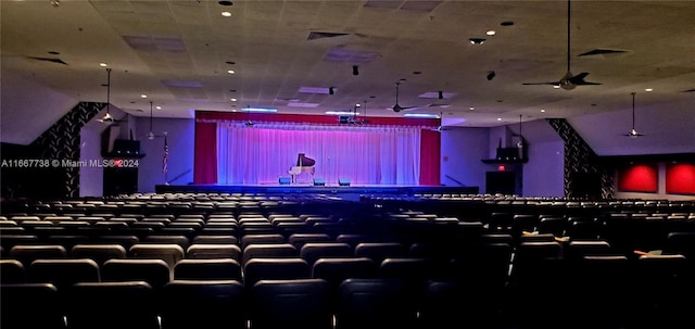 carpeted cinema featuring ceiling fan