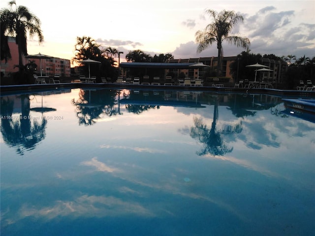 view of pool at dusk