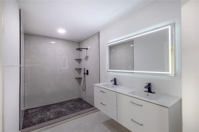 bathroom featuring tiled shower, vanity, and tile patterned floors