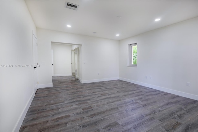 empty room with dark wood-type flooring