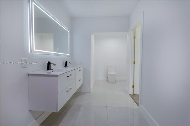 bathroom featuring vanity, toilet, and tile patterned floors