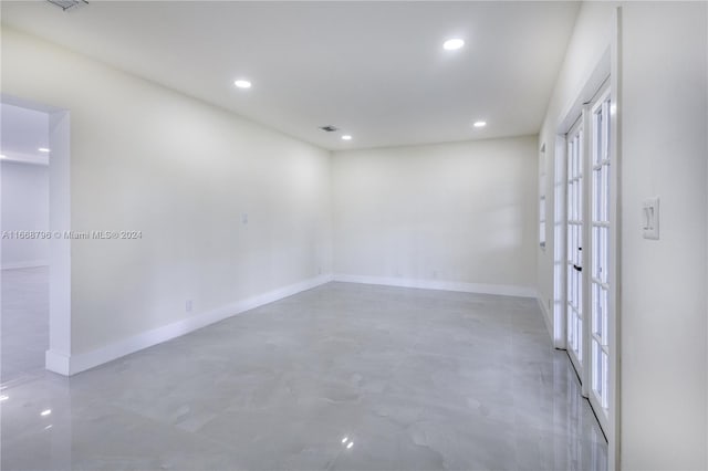 unfurnished room featuring french doors