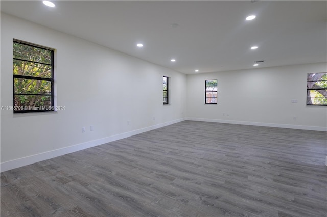 unfurnished room featuring hardwood / wood-style floors and plenty of natural light