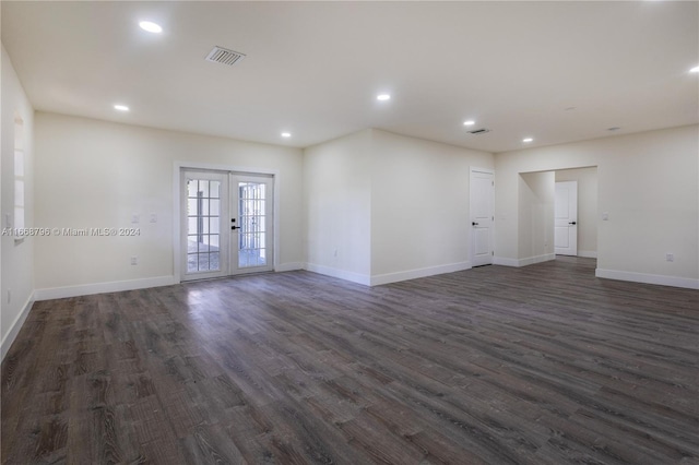 spare room featuring dark hardwood / wood-style flooring and french doors