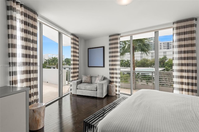 bedroom featuring access to outside, hardwood / wood-style floors, and multiple windows