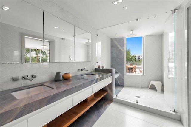 bathroom featuring a healthy amount of sunlight, an enclosed shower, and vanity