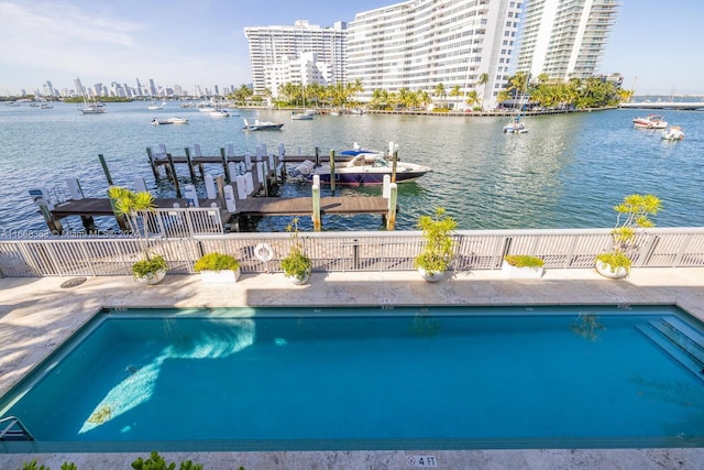 view of pool featuring a boat dock and a water view