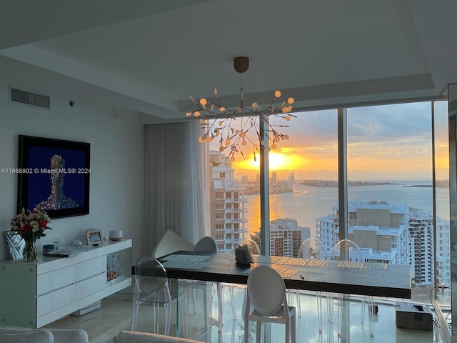 dining space with a water view and a healthy amount of sunlight