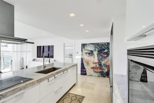 kitchen with white cabinets, sink, black electric cooktop, exhaust hood, and light stone countertops