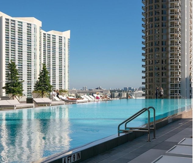 view of pool with a water view