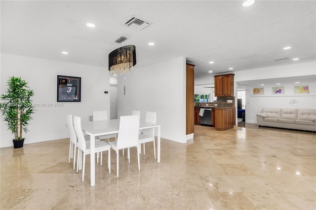 dining space featuring an inviting chandelier