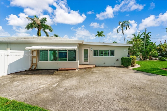 rear view of property with a lawn