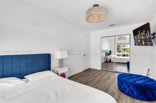 bedroom featuring wood-type flooring and a closet