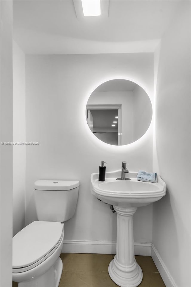 bathroom with tile patterned flooring and toilet