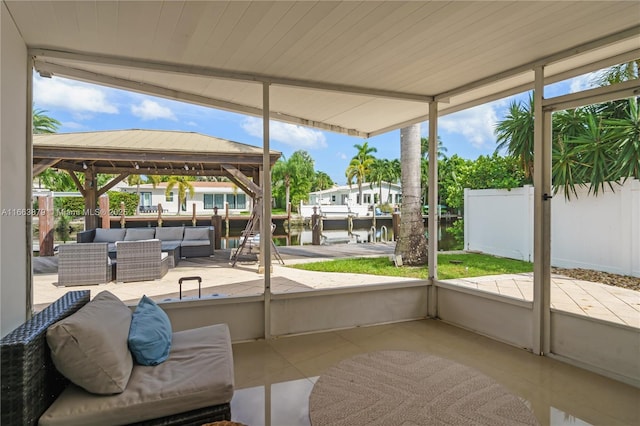 sunroom with a healthy amount of sunlight and a water view