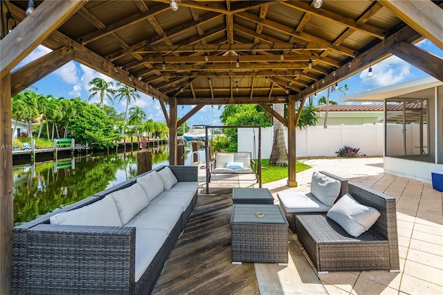 view of patio / terrace with a gazebo, an outdoor hangout area, and a water view