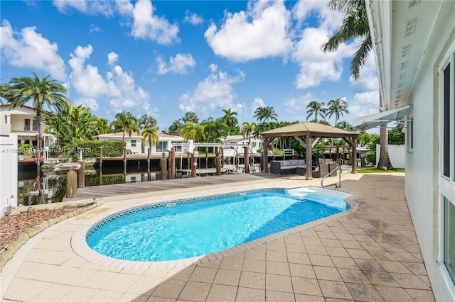 view of pool with a gazebo, an outdoor living space, a water view, and a patio