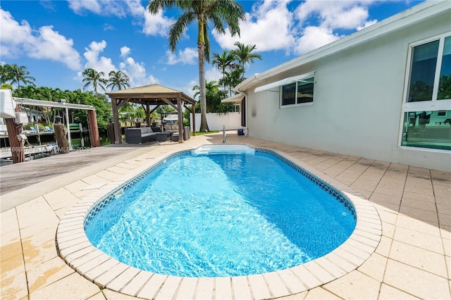 view of swimming pool with outdoor lounge area, a gazebo, and a patio area