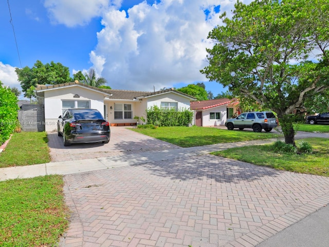 view of front facade with a garage and a front lawn