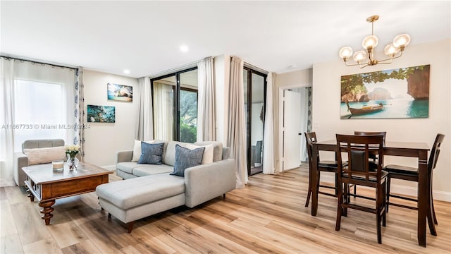 living room featuring a chandelier and light hardwood / wood-style flooring