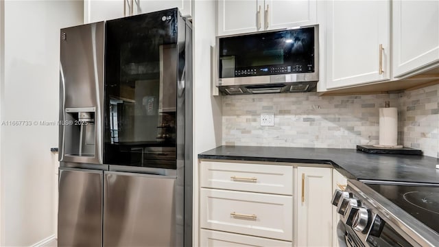 kitchen featuring stainless steel appliances, white cabinetry, and tasteful backsplash