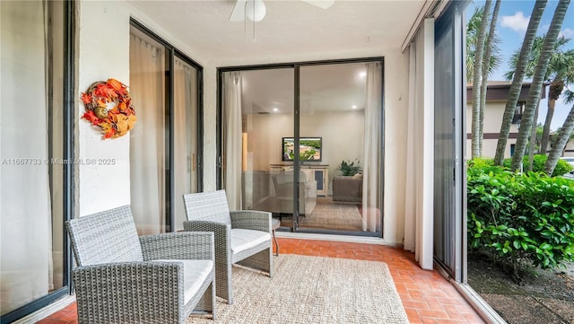 sunroom with a ceiling fan