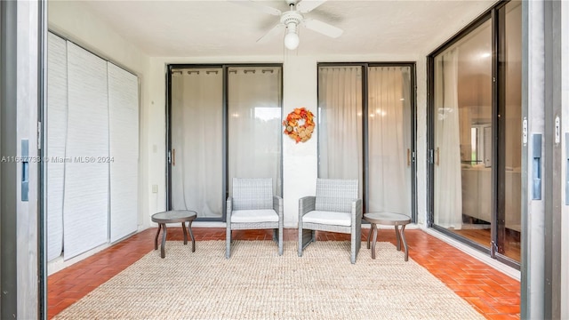 interior space with ceiling fan