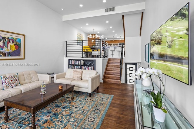 living room with a chandelier and dark hardwood / wood-style floors