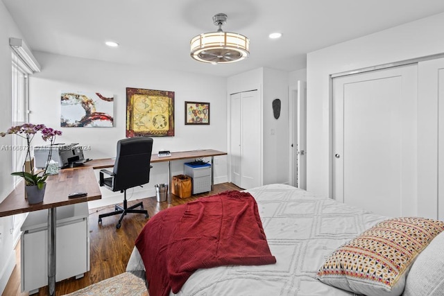 bedroom with dark hardwood / wood-style flooring