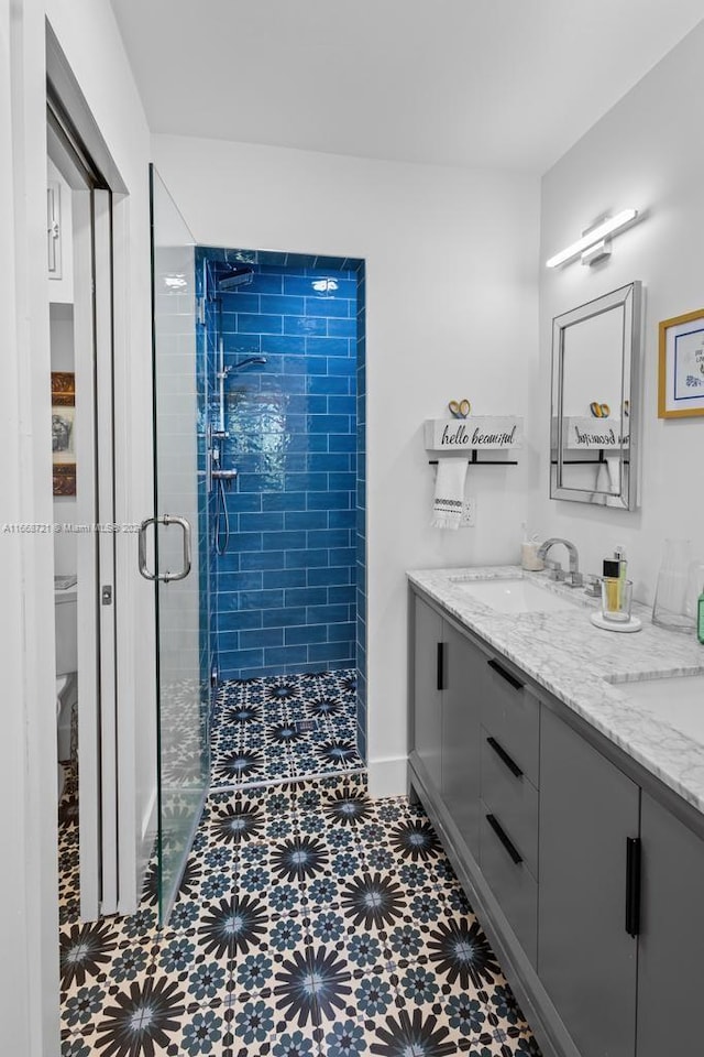 bathroom featuring vanity, toilet, and a shower with door