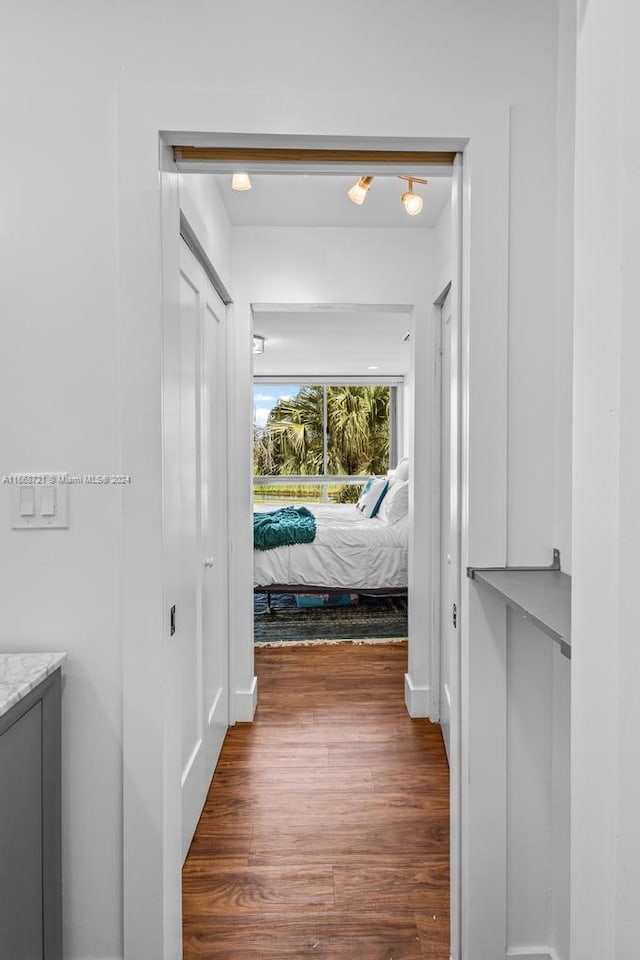 corridor with dark hardwood / wood-style floors