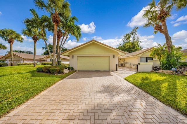 ranch-style house featuring a front lawn, a tile roof, a gate, decorative driveway, and a garage