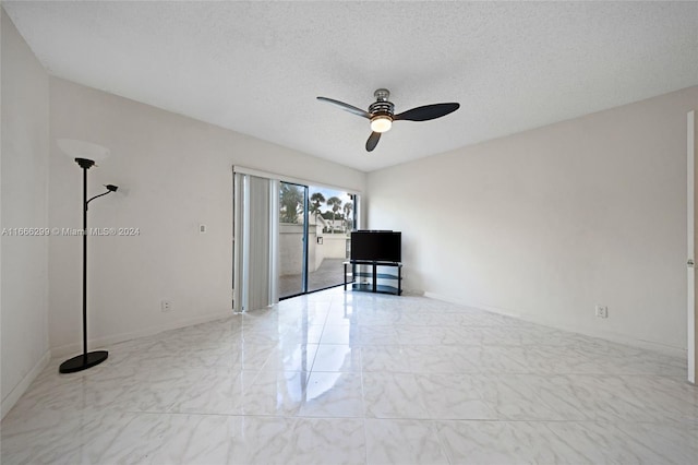 unfurnished room featuring ceiling fan and a textured ceiling