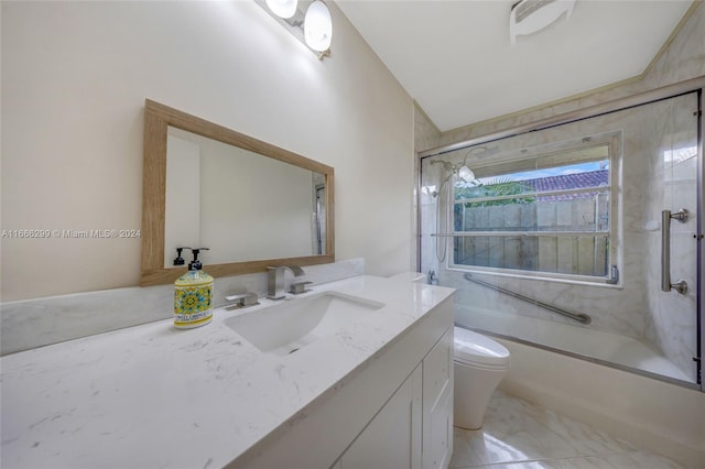 full bathroom featuring toilet, vanity, and combined bath / shower with glass door