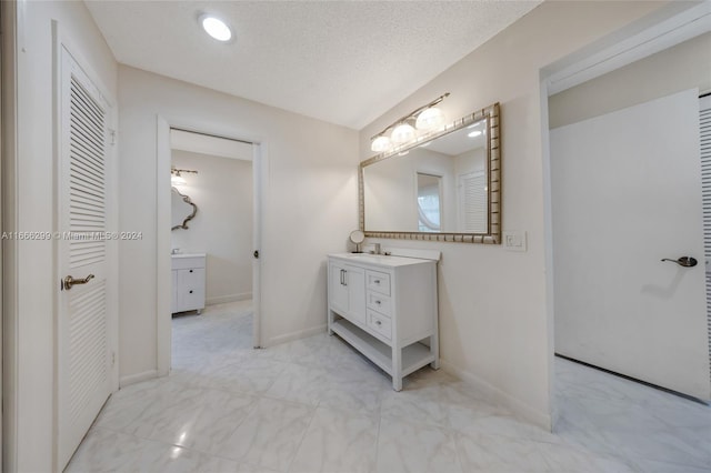 bathroom with vanity and a textured ceiling