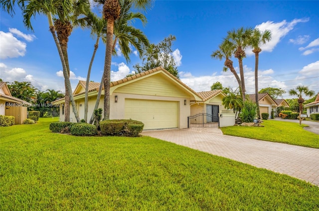 ranch-style house with a garage and a front lawn