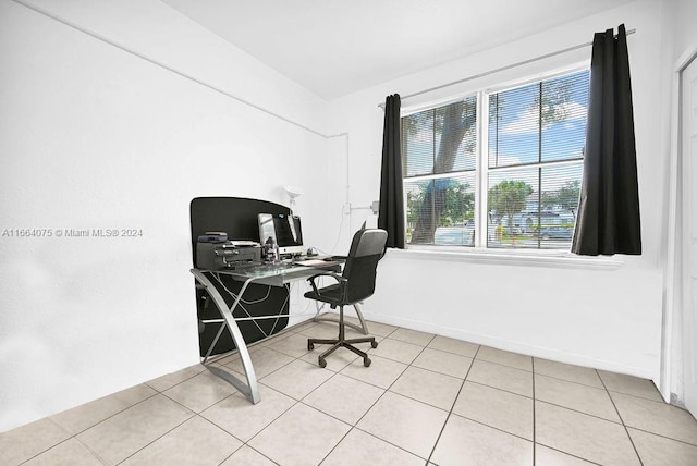 tiled home office with a healthy amount of sunlight