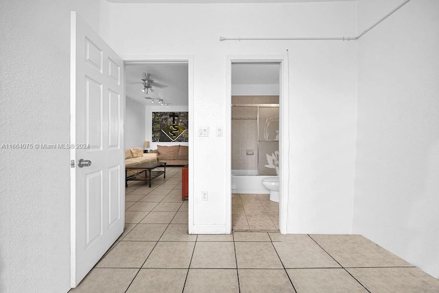 interior space with light tile patterned flooring and connected bathroom