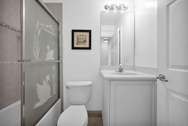 full bathroom with tile patterned floors, enclosed tub / shower combo, vanity, and toilet