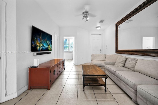 tiled living room with ceiling fan