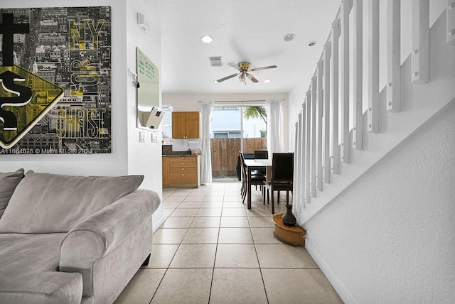 tiled living room featuring ceiling fan