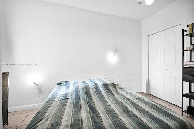 unfurnished bedroom featuring a closet and light tile patterned flooring