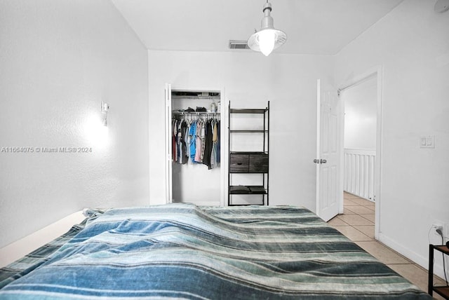 bedroom with a closet and light tile patterned floors