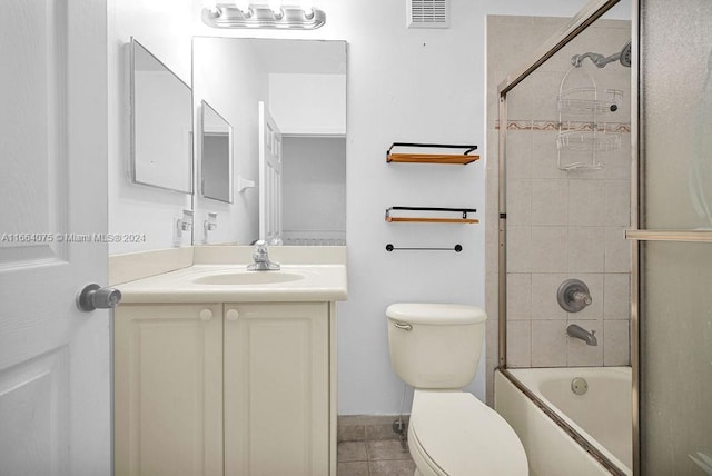 full bathroom with enclosed tub / shower combo, vanity, toilet, and tile patterned floors